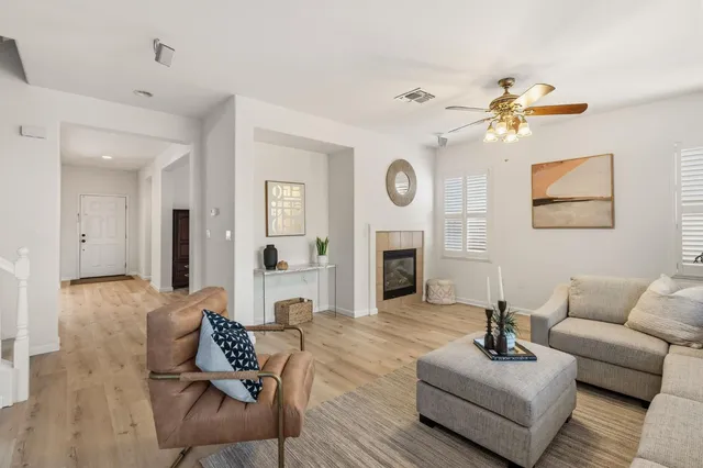 a living room with furniture a clock and a fireplace