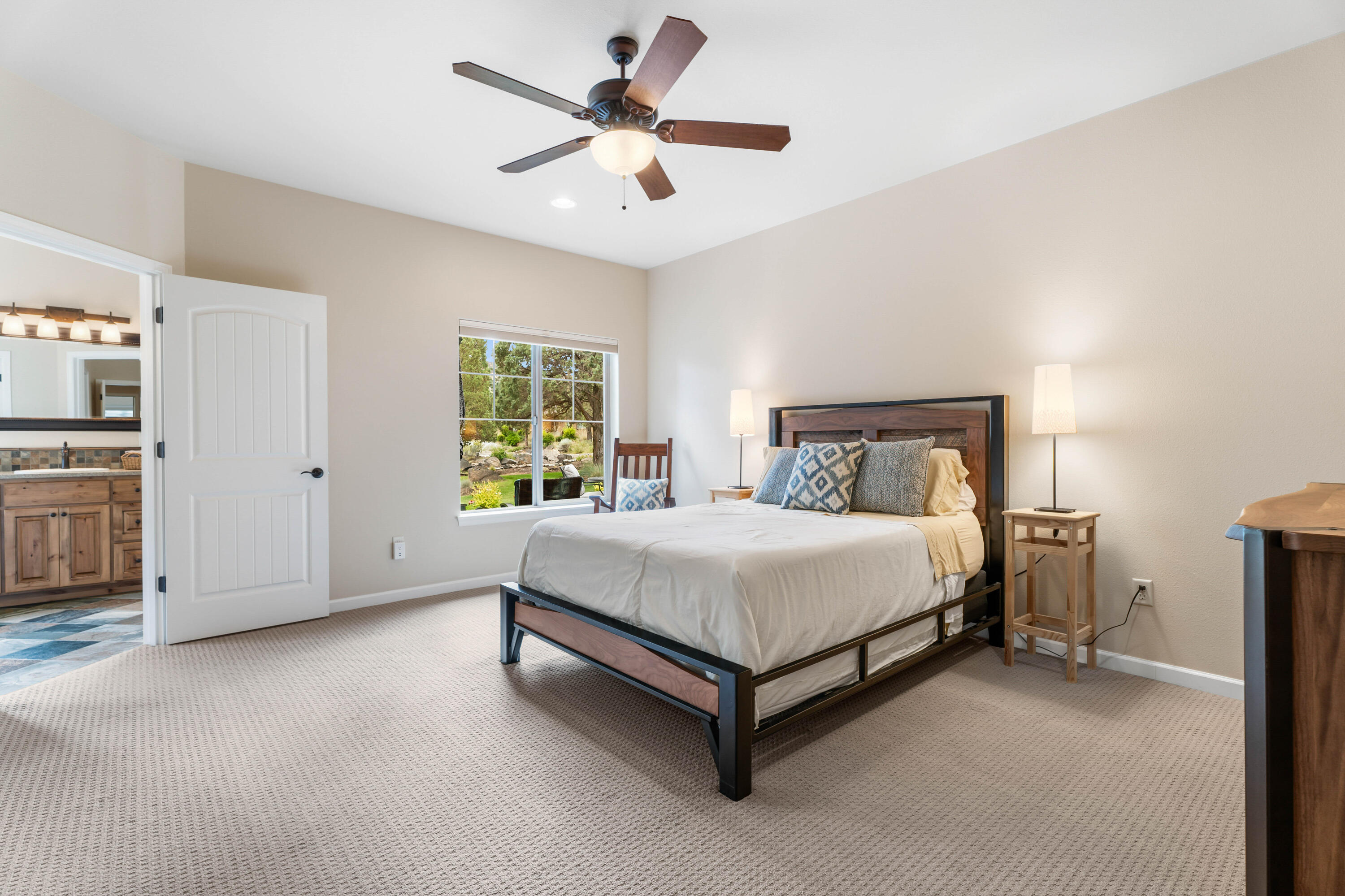 205 Vista Rim Drive Redmond, OR 97756 - Photo 23 of 85 a bedroom with a bed and a ceiling fan