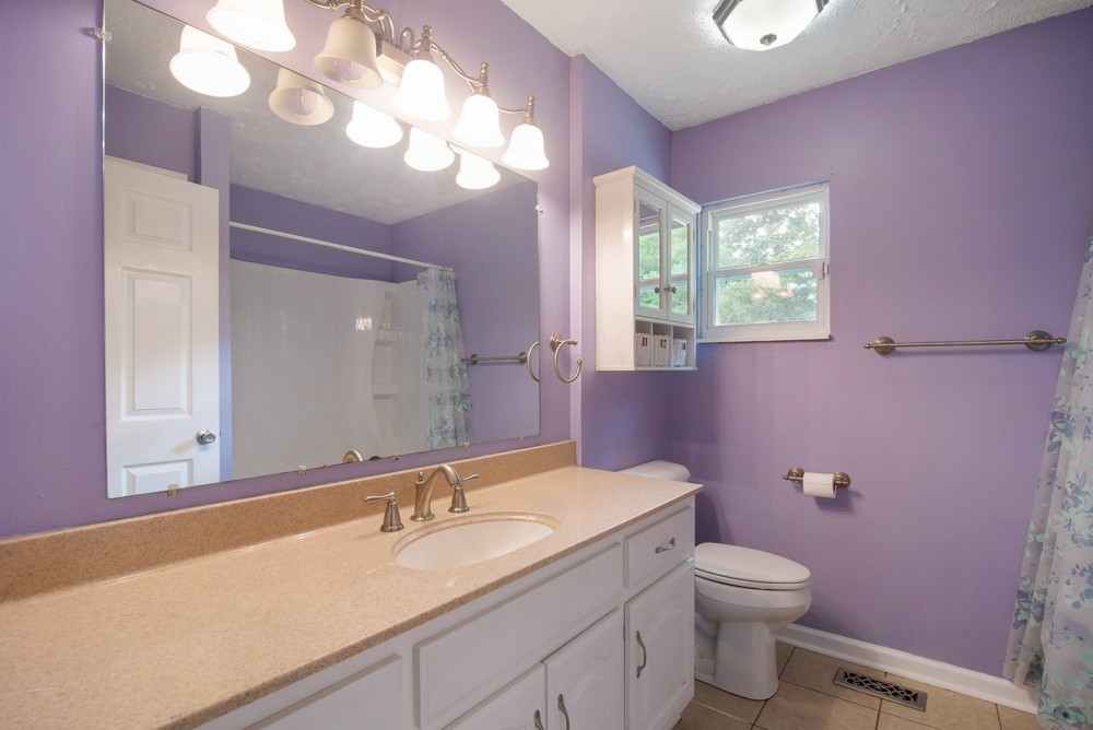 156 Vantrease Lane Gallatin, TN 37066 - Photo 17 of 37 a bathroom with a granite countertop sink a toilet and a mirror