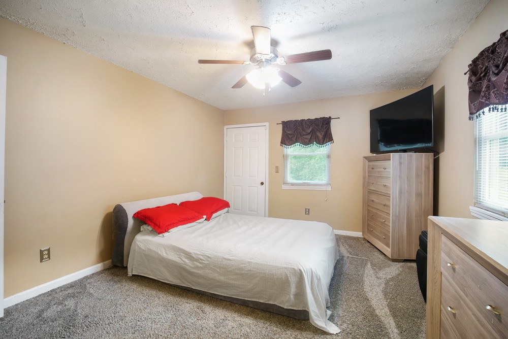 156 Vantrease Lane Gallatin, TN 37066 - Photo 23 of 37 a spacious bedroom with a bed and a flat screen tv