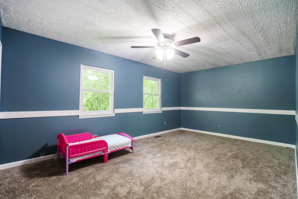156 Vantrease Lane Gallatin, TN 37066 - Photo 25 of 37 a bedroom with a bed and a chandelier