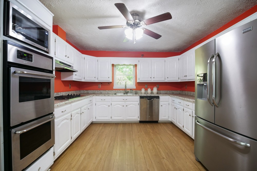 156 Vantrease Lane Gallatin, TN 37066 - Photo 6 of 37 a kitchen with granite countertop a refrigerator stove top oven and sink