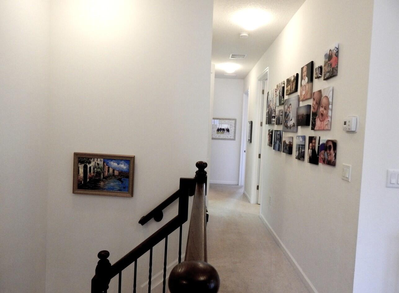 4820 Northwest 16th Terrace Boca Raton, FL 33431 - Photo 11 of 39 a view of a hallway with paintings on the wall