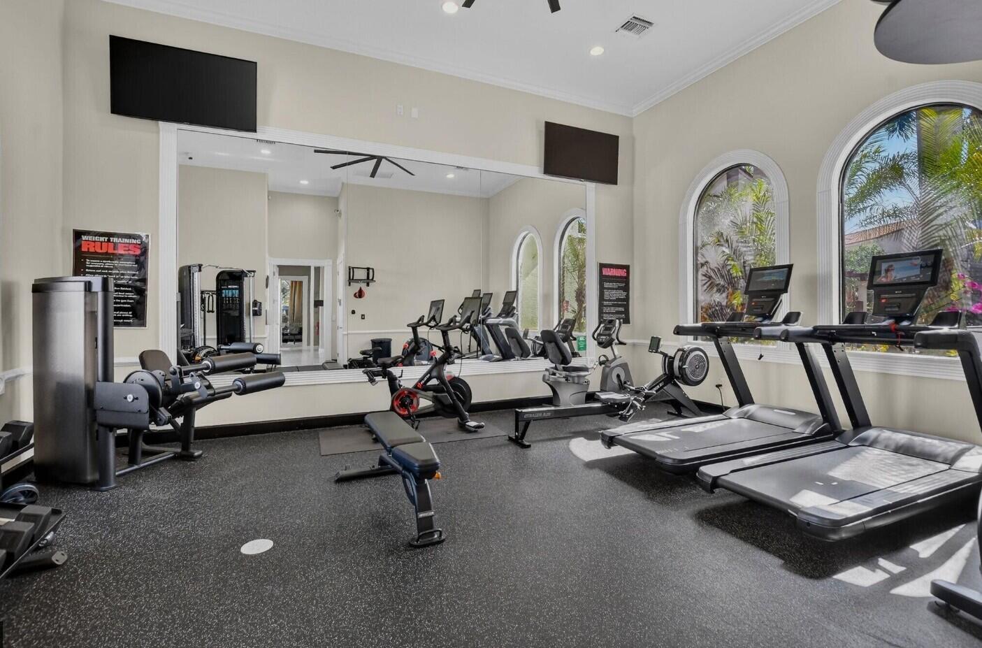 4820 Northwest 16th Terrace Boca Raton, FL 33431 - Photo 33 of 39 a living room with furniture gym equipment and a flat screen tv