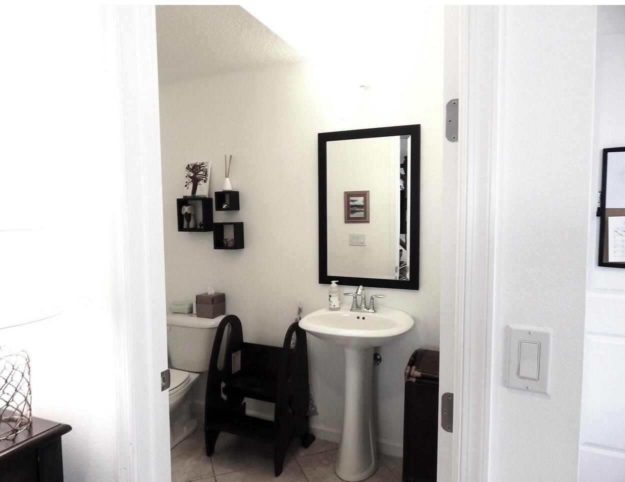 4820 Northwest 16th Terrace Boca Raton, FL 33431 - Photo 10 of 39 a bathroom with a sink mirror and a toilet