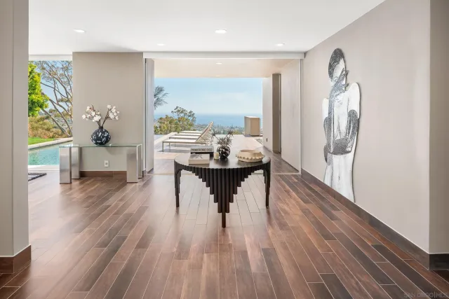 a living room with furniture and a floor to ceiling window