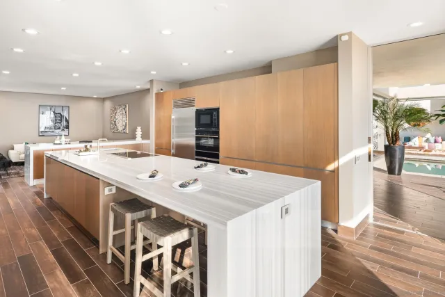 a kitchen with a sink a counter top space stainless steel appliances and a large window