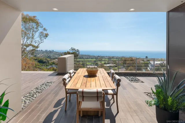 a view of a roof deck with couches and potted plants