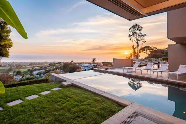 a vase of flowers sitting on a table in a kitchen
