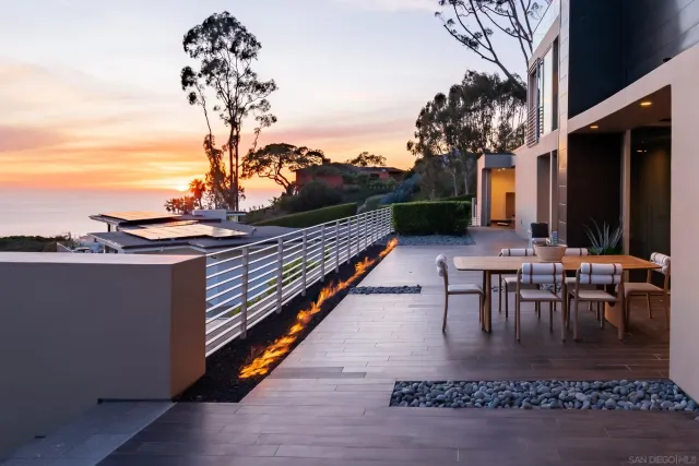a view of roof deck with couches and city view