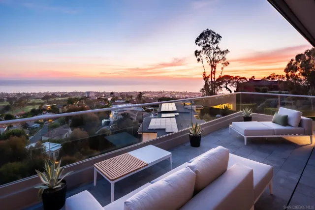 a view of a chairs and table in the balcony