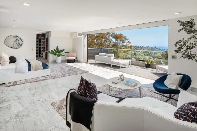 a view of a dining room with furniture a rug and wooden floor