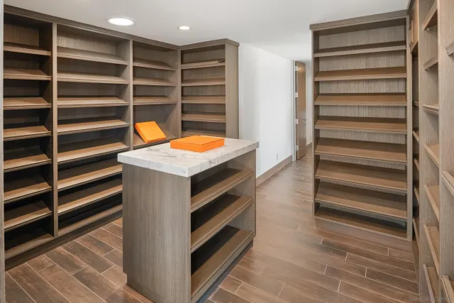 a view of a balcony with wooden floor and fence