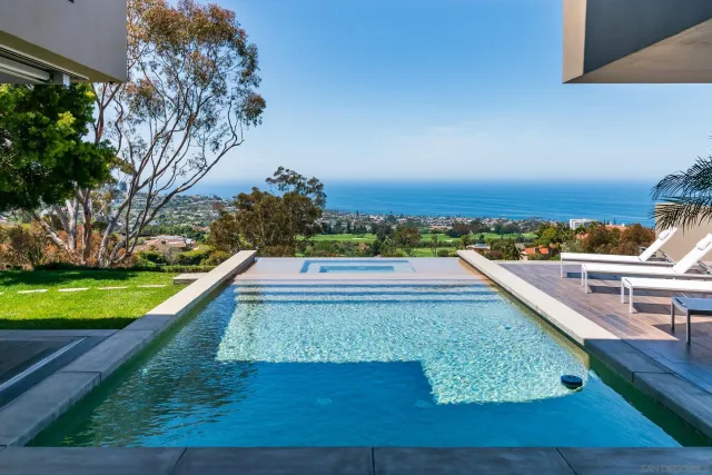 a view of a yard with a wooden fence