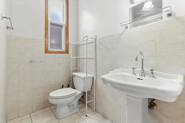 a bathroom with a sink a toilet and mirror