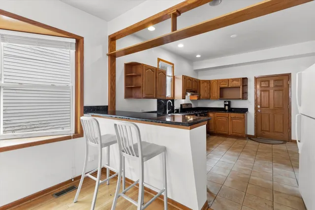 a kitchen with a sink cabinets and window
