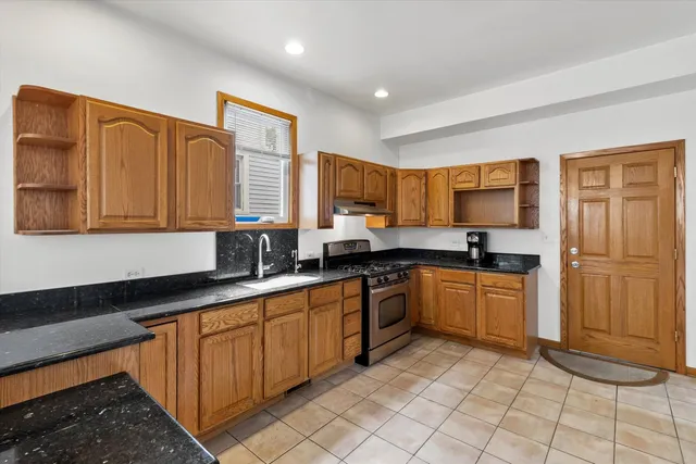 a kitchen with stainless steel appliances granite countertop a sink and cabinets