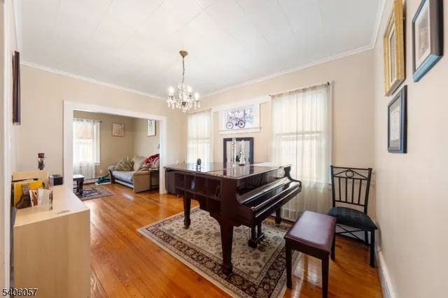 a living room with furniture and a chandelier