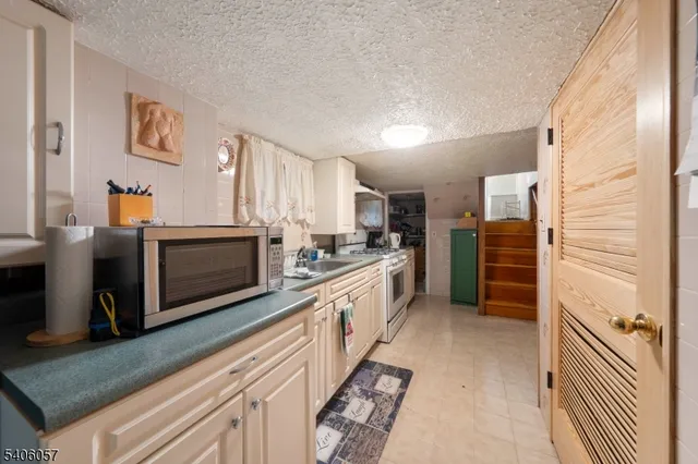 a large kitchen with cabinets wooden floor and stainless steel appliances