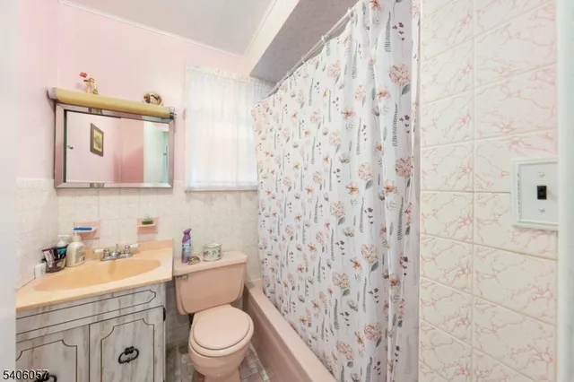 a white toilet sitting next to a bathroom sink