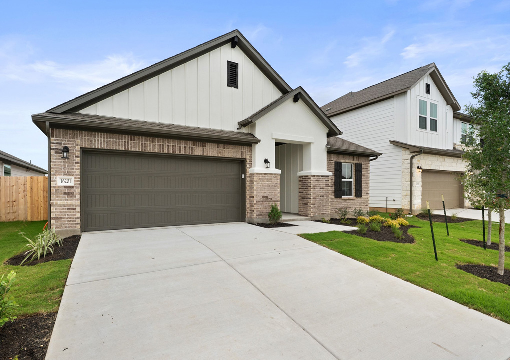 16201 Smithers Road Manor, TX 78653 - Photo 2 of 40 a front view of house with yard and green space