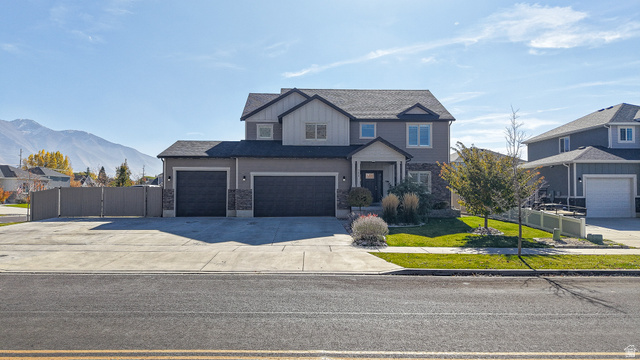368 East 700 North Springville, UT 84663 - Photo 52 of 55 View of front of home featuring driveway, an attached garage, a gate, a mountain view, and a residential view