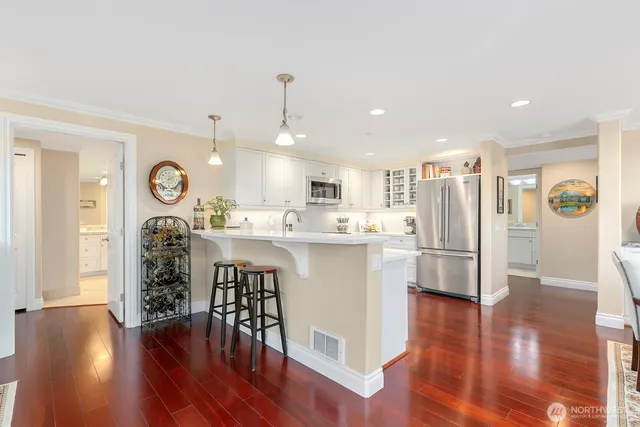 a kitchen with stainless steel appliances a stove a microwave and cabinets
