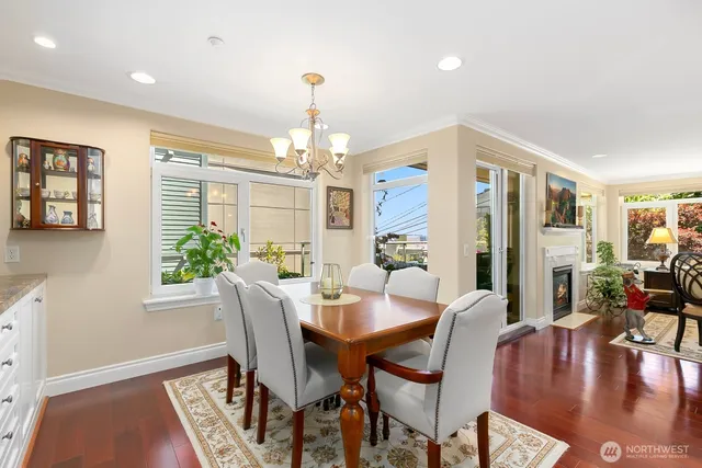 a view of a dining room with furniture a chandelier and wooden floor