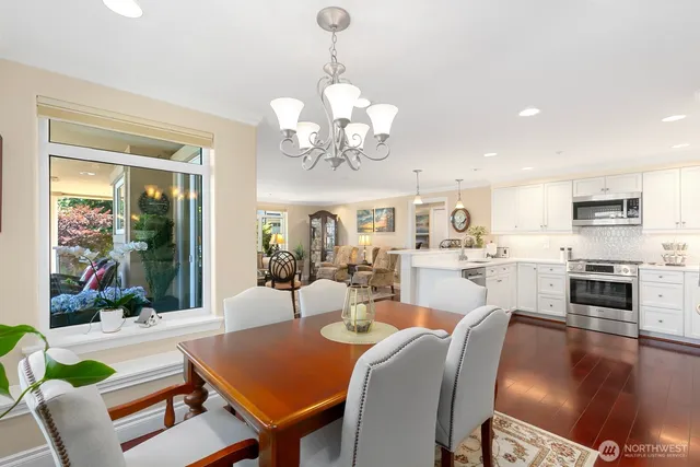 a view of a dining room with furniture and a chandelier