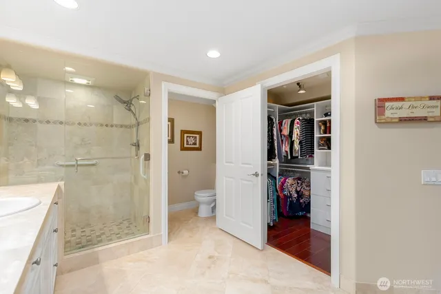 a view of walk in closet with clothes and shoes