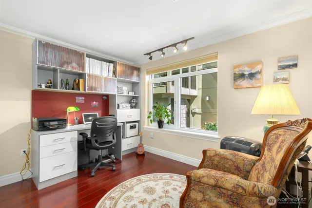 a bathroom with a granite countertop sink a toilet a mirror a vanity and shower