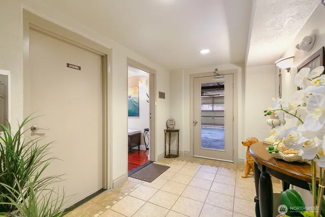 a view of a hallway with wooden floor and a potted plant