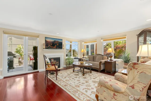 a living room with furniture a fireplace and a table