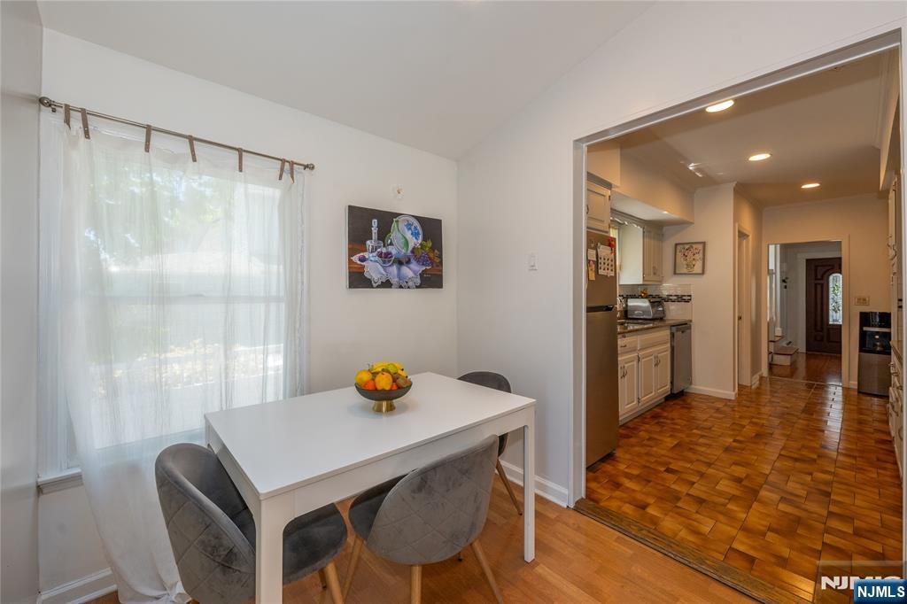690 Garden Street Maywood, NJ 07607 - Photo 16 of 49 a kitchen with stainless steel appliances a dining table chairs and refrigerator