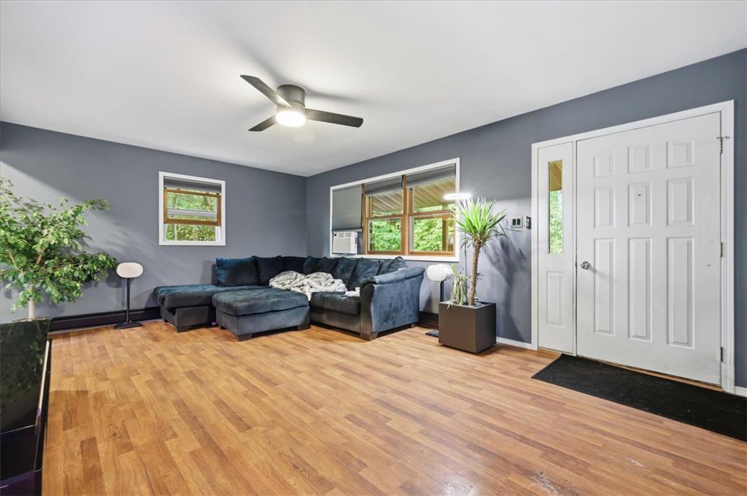 520 Highland Hill Road Jim Thorpe, PA 18235 - Photo 5 of 83 Natural light illuminates this inviting living space with durable hardwood-style flooring and a refreshing ceiling fan.