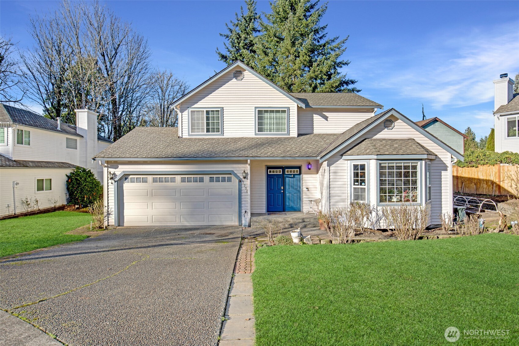 a front view of house with yard and green space