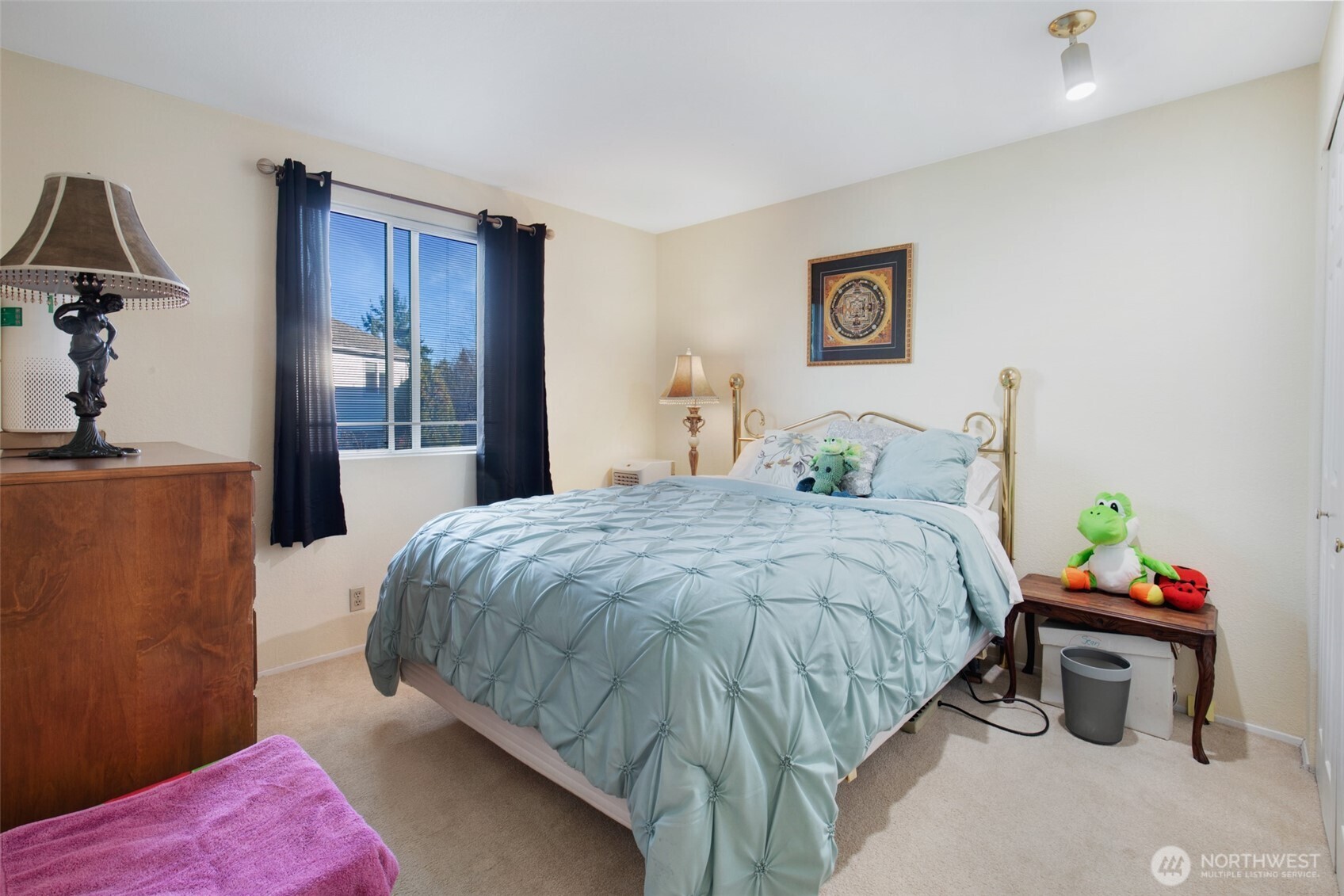 11908 Northeast 168th Street Bothell, WA 98011 - Photo 13 of 30 a bed sitting in a bedroom and a table in it