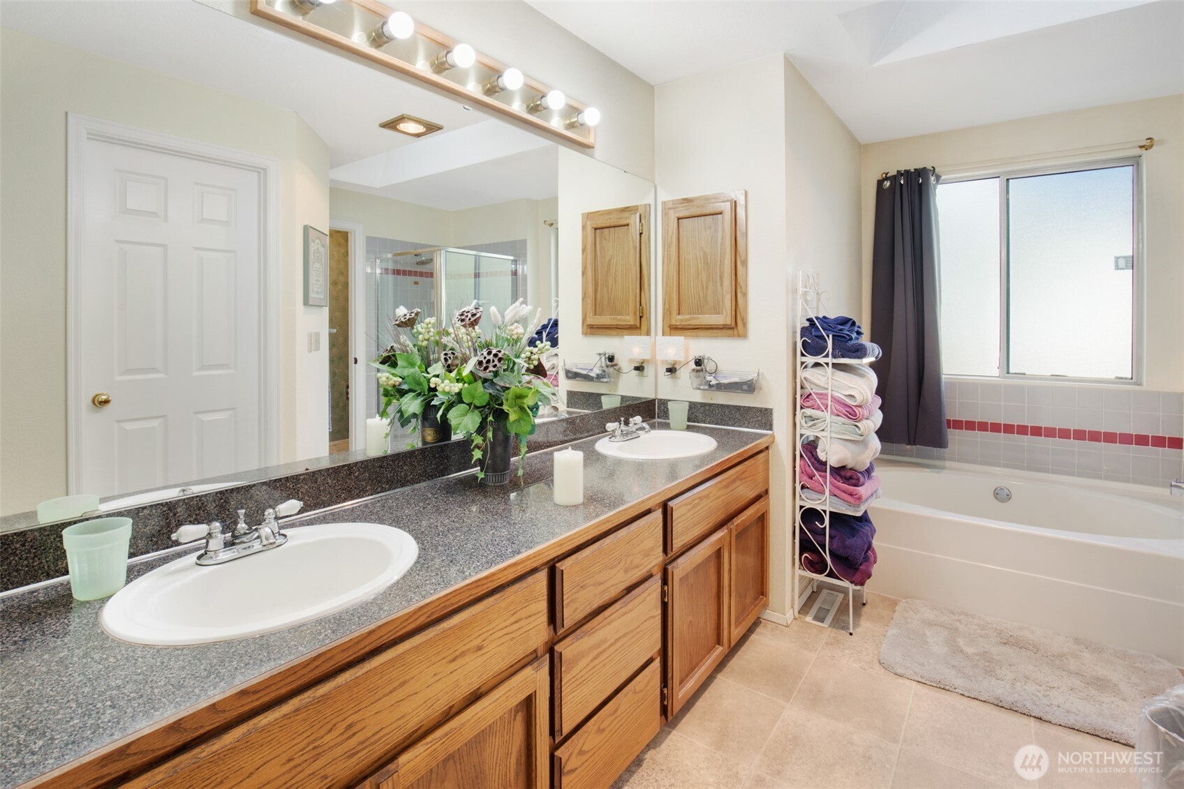 11908 Northeast 168th Street Bothell, WA 98011 - Photo 18 of 30 a bathroom with a sink double vanity granite tub shower and a mirror