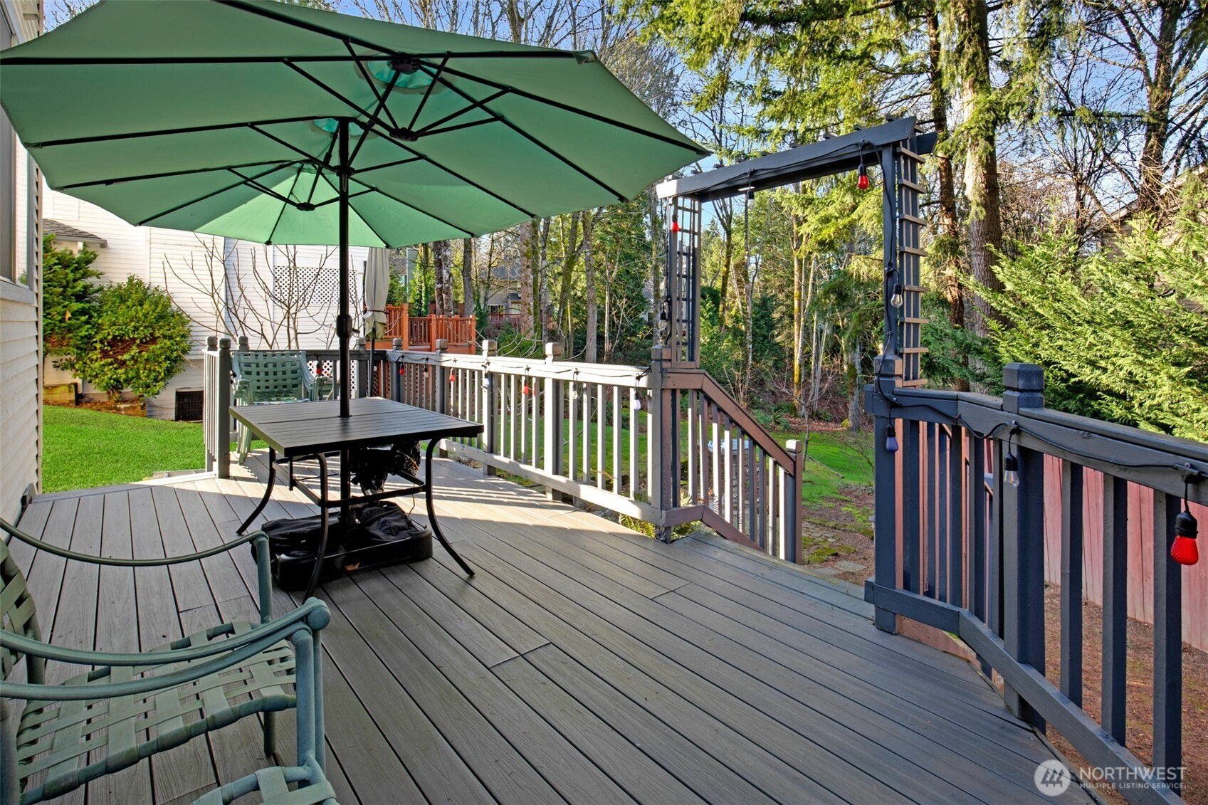 11908 Northeast 168th Street Bothell, WA 98011 - Photo 24 of 30 a view of balcony with furniture and umbrella