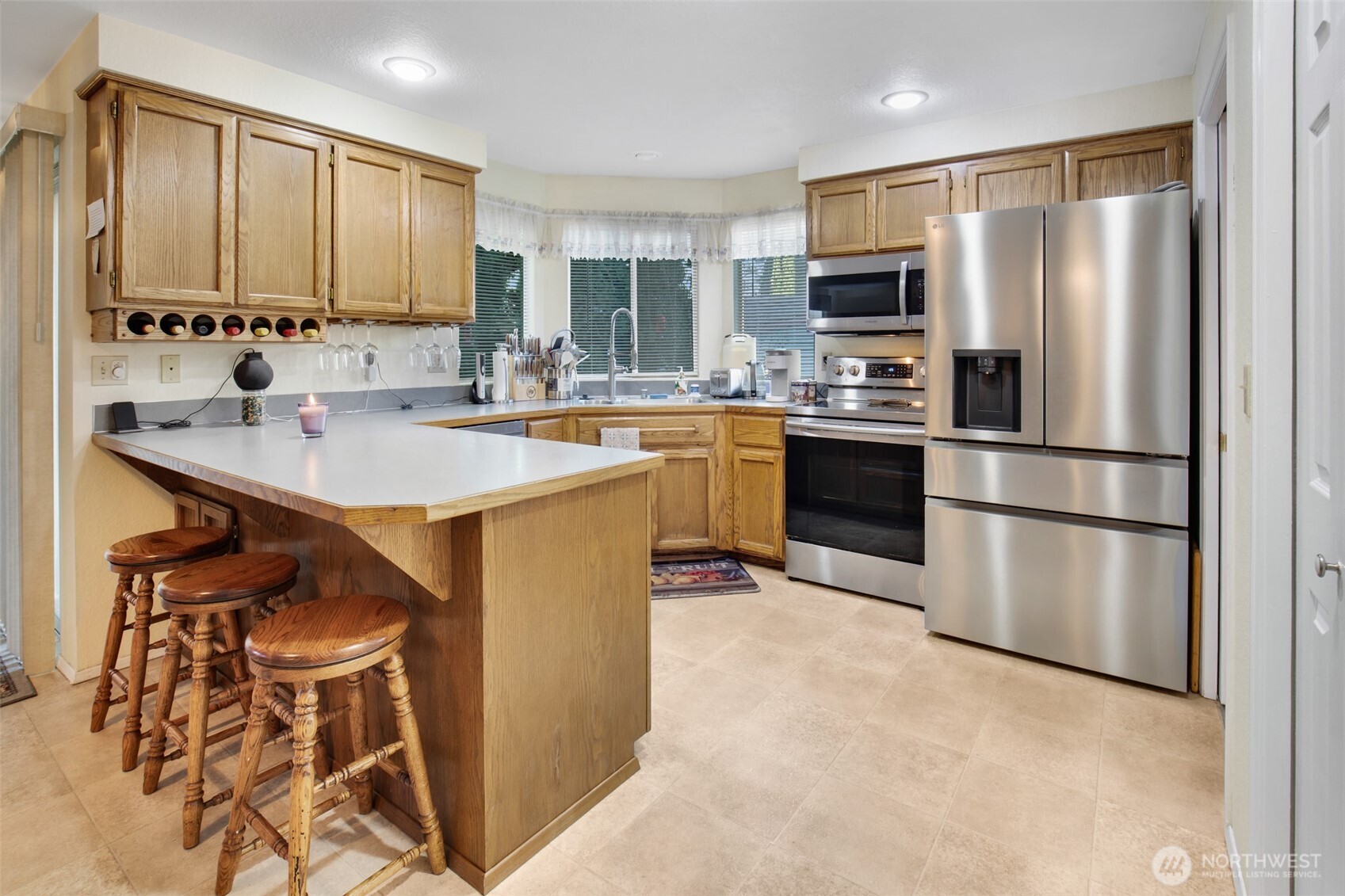 11908 Northeast 168th Street Bothell, WA 98011 - Photo 3 of 30 a kitchen with kitchen island a counter top space stainless steel appliances and cabinets