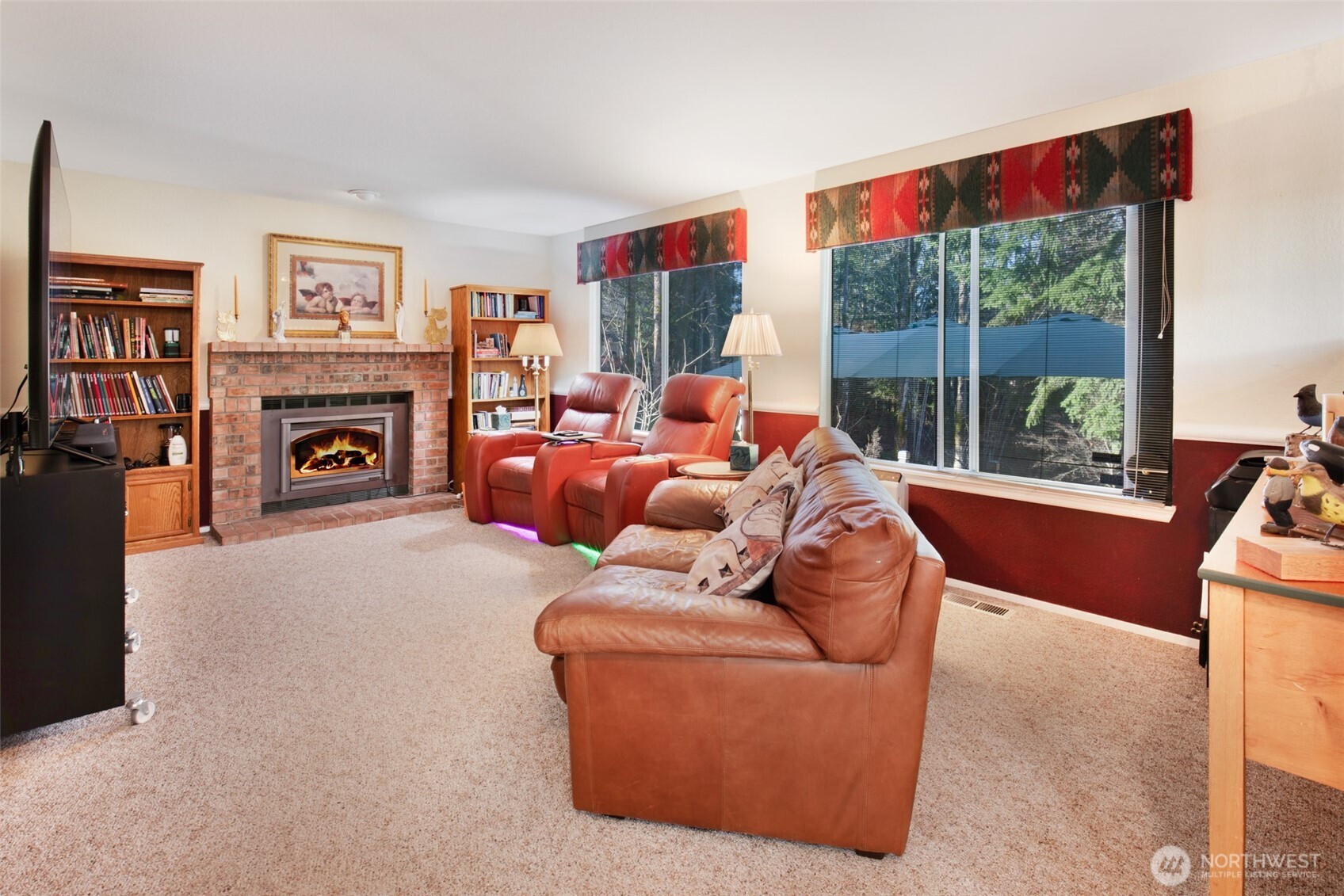 11908 Northeast 168th Street Bothell, WA 98011 - Photo 8 of 30 a living room with furniture a fireplace and a floor to ceiling window