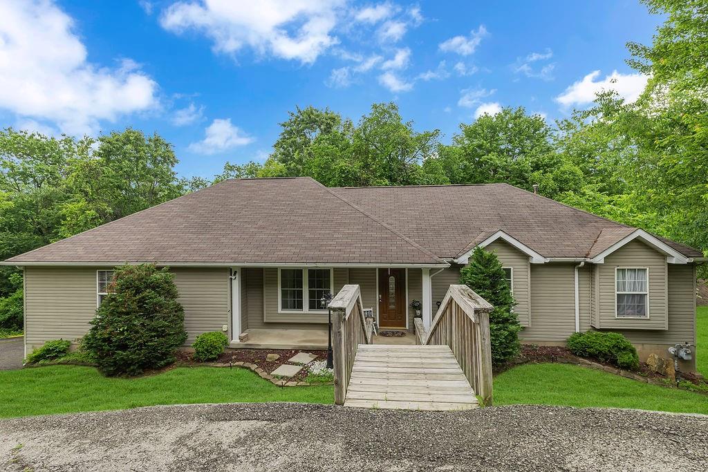a front view of a house with a garden