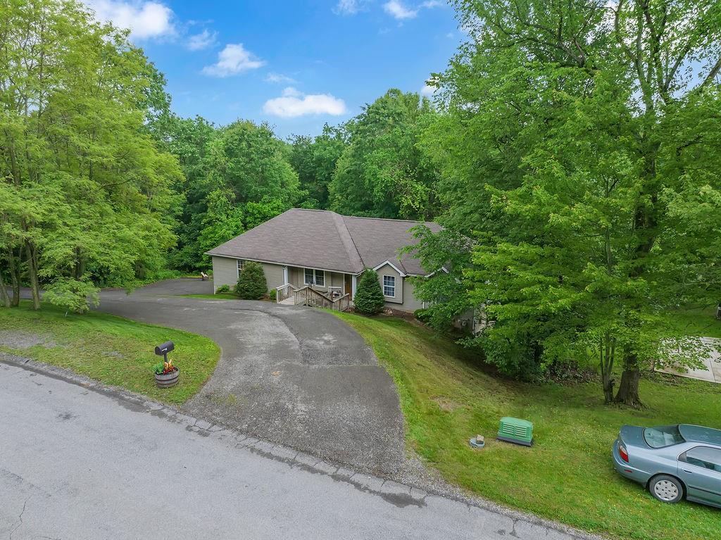 6014 Forest Drive Monaca, PA 15061 - Photo 32 of 32 a view of a garden with a table and chairs under an umbrella
