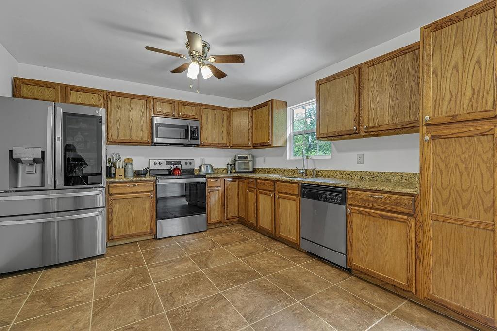 6014 Forest Drive Monaca, PA 15061 - Photo 10 of 32 a kitchen with stainless steel appliances granite countertop a stove sink and cabinets