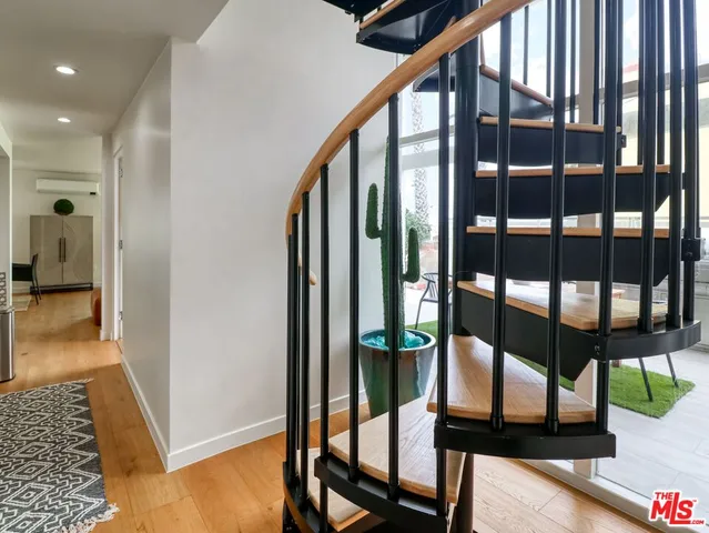 a bedroom with furniture and wooden floor