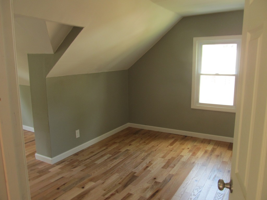 67 Clough Street Springfield, MA 01118 - Photo 18 of 22 an empty room with wooden floor and windows