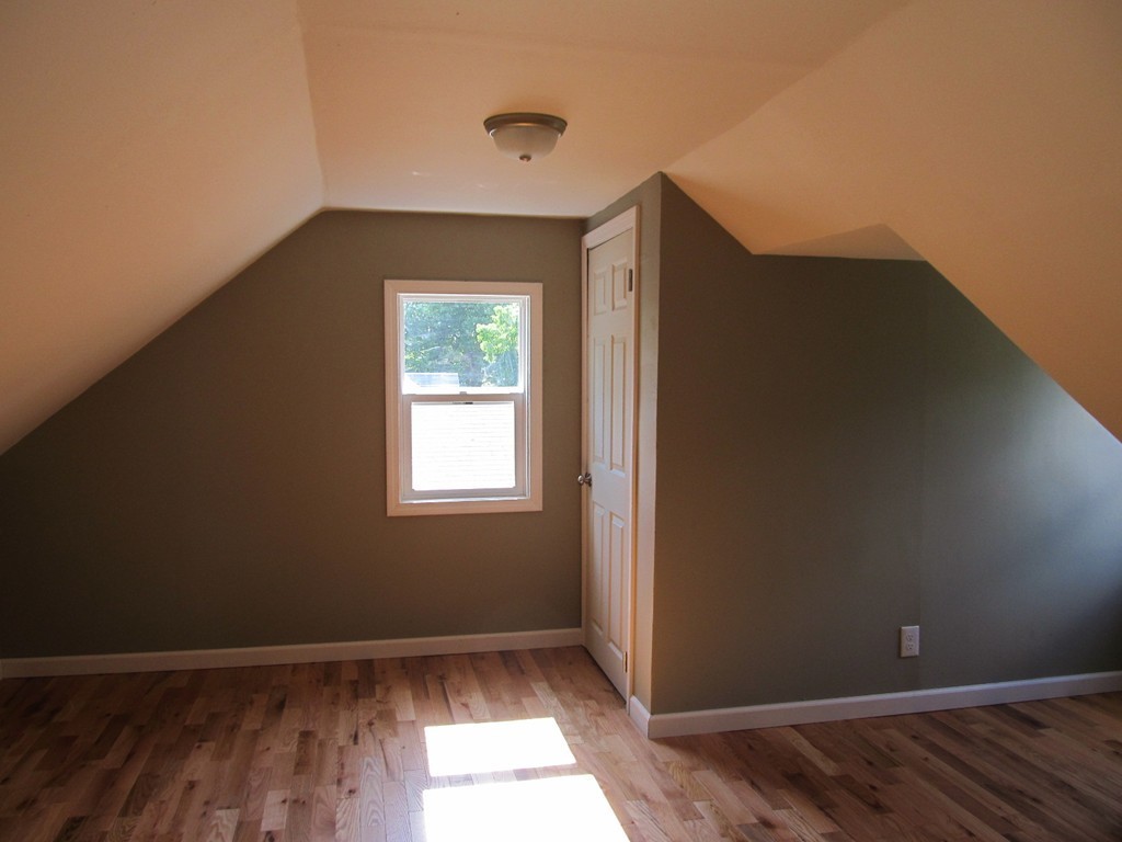 67 Clough Street Springfield, MA 01118 - Photo 21 of 22 an empty room with wooden floor and windows