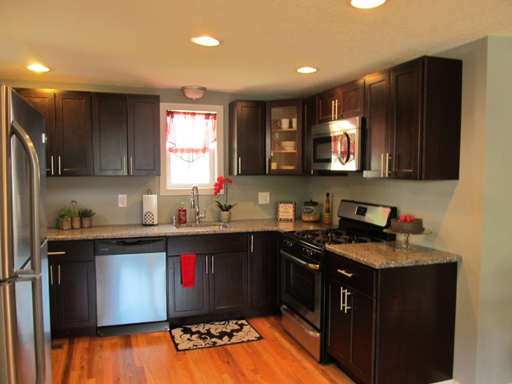 67 Clough Street Springfield, MA 01118 - Photo 4 of 22 a kitchen with stainless steel appliances granite countertop a stove a sink and a microwave