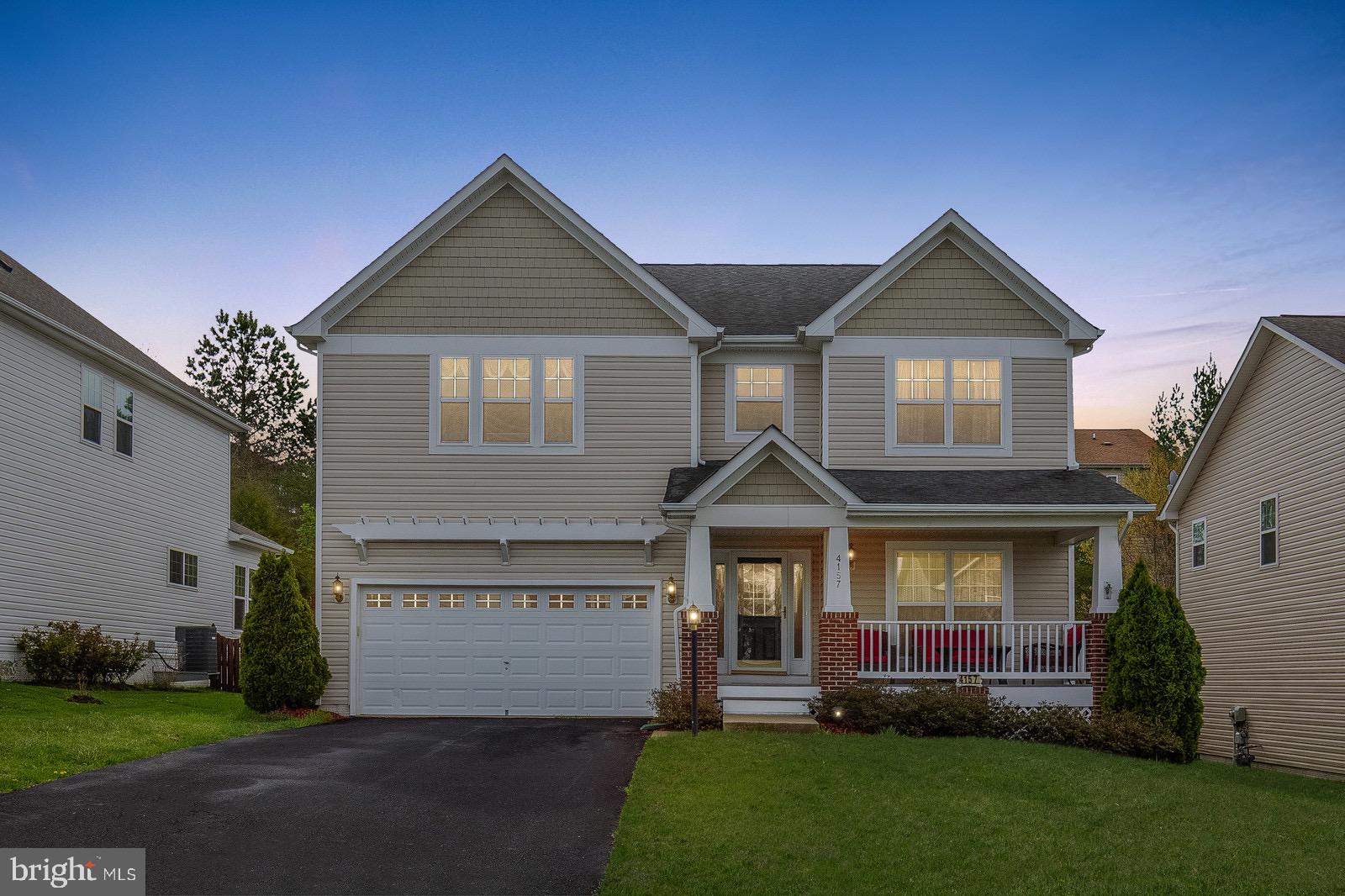 4157 Agency Loop Triangle, VA 22172 - Photo 1 of 30 a front view of a house with a yard and garage