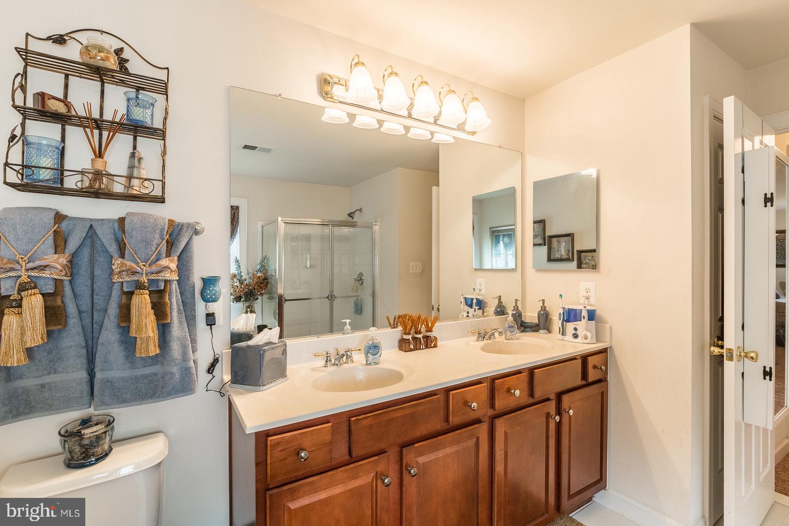 4157 Agency Loop Triangle, VA 22172 - Photo 20 of 30 a bathroom with a sink double vanity and a mirror